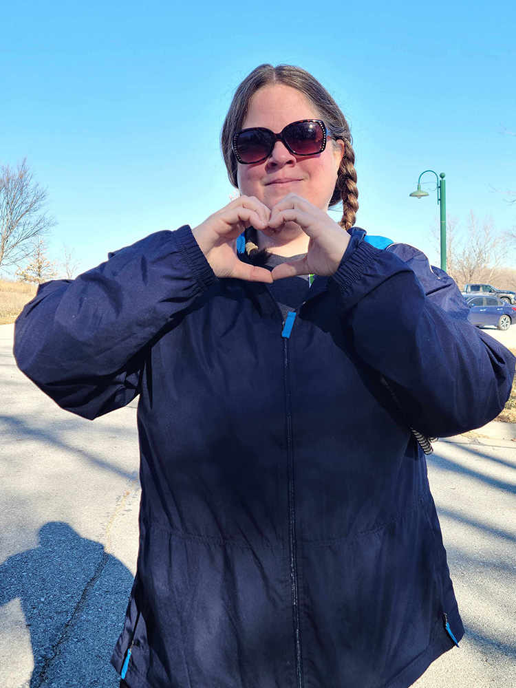 woman holding heart shape with her hands